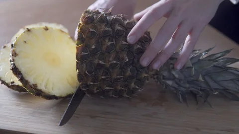 A woman's hand cuts pineapple rings 스톡 동영상 127650662