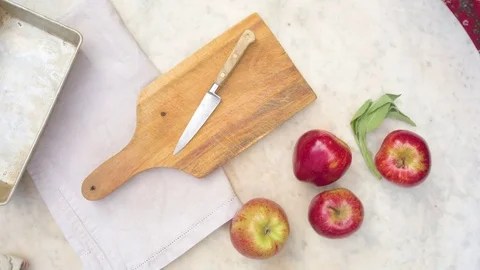 Woman's hand cutting an apple on chopping board Video stock 76100103