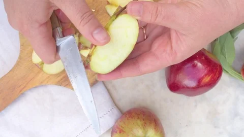 Woman's hand cutting apple in kitchen Stock Footage 76100114