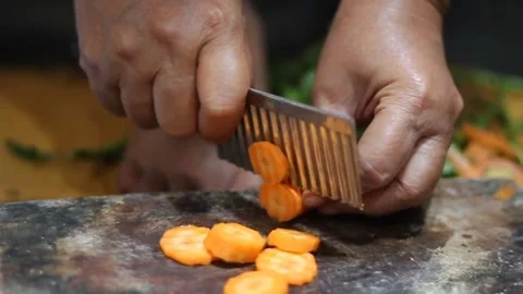 Woman's hand cutting carrots Stock Footage 302964306