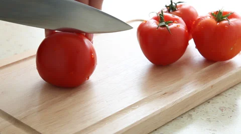 Woman’s hand cutting ripe tomatoes - macro shot Stock Footage 30348628
