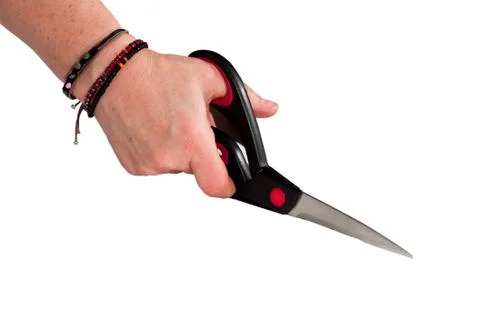 Womans hand cutting with scissors Stock Photos