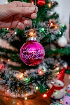 Woman's hand decorating a Christmas tree. Stock Photos