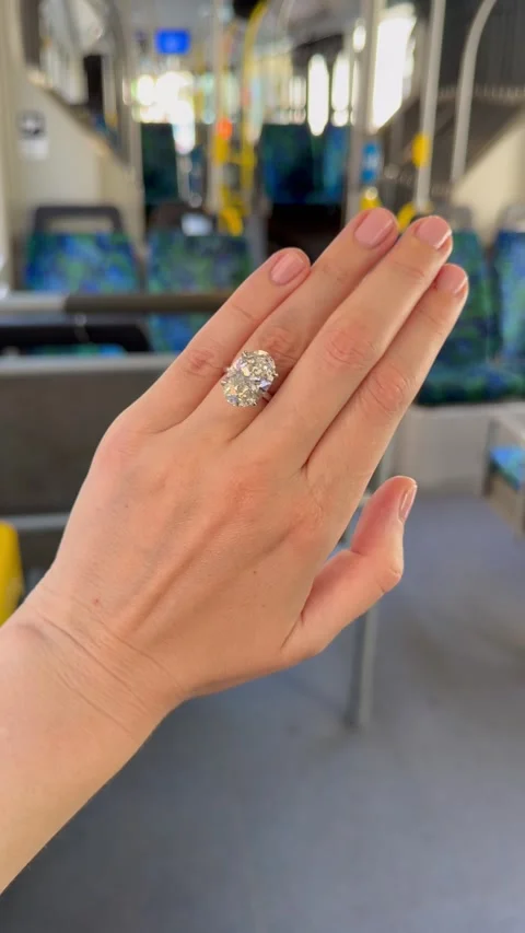 Woman’s hand with diamond ring inside city bus vertical video Video stock 316754675