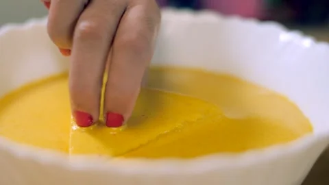Woman's hand dipping stuffed bread in besan batter to make fresh bread pakora Video stock 155043653