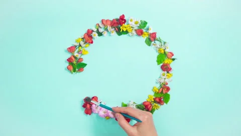 Woman's hand draws circle with brush from natural flowers and buds. Stock Footage 188840792