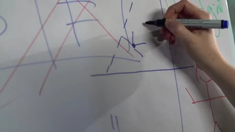 Woman's hand draws dots and lines on a paper board with a blue felt-tip pen Stock Footage 240750549