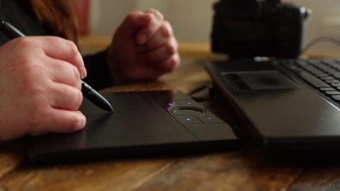 Woman's hand draws on a graphics tablet Stock Footage 128949464