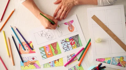 A woman's hand draws a multi-colored storyboard for a film or cartoon. Top view  Stock Footage 138774570