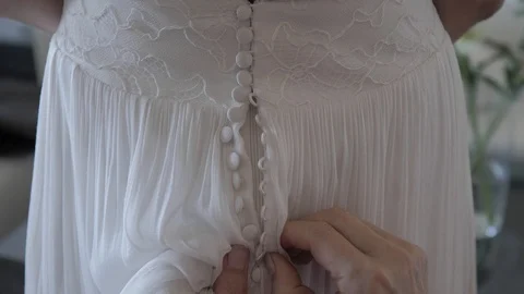Woman's hand dressing a bride at the wedding 動画素材 120578905