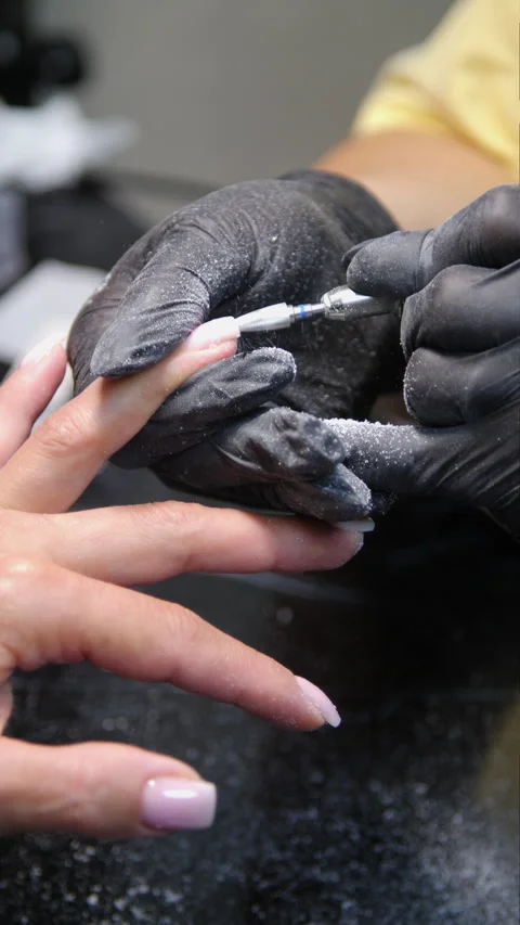 A woman's hand during a manicure - Vertical video Stock Footage 339780976