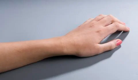 Womans hand on empty gray background Stock Photos