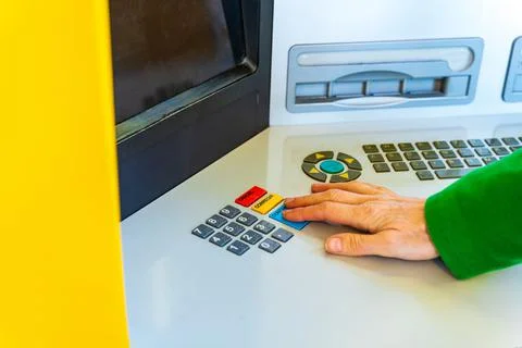 Woman's hand enter pin code in a Atm Stock-Fotos