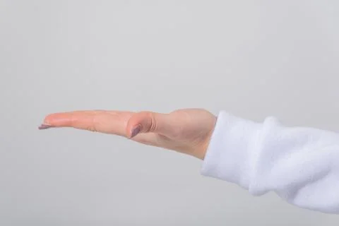 Woman's hand extending an open palm, ready for product placement or display.. Stock Photos