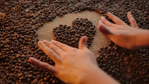 Woman's hand form heart shape illustration made of roasted arabica coffee grains Stock Footage 135724872
