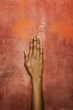 A woman's hand in front of a wall Stock Photos