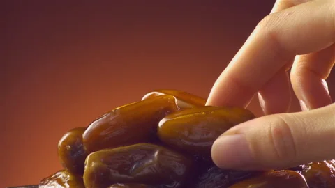 Woman’s hand grabs a piece of date from plate. Dolly shot Stock Footage 147224718