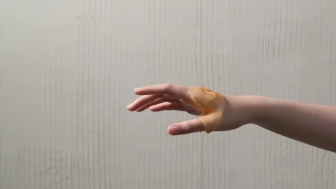 A woman's hand is gracefully draped in golden honey, creating a visually ca.. Stock Footage 304213376