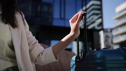 Woman's hand with handle of suitcase. Close up Stock Footage 263702242