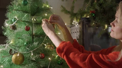Womans hand hang christmas ball in christmas tree. New year and christmas Stock Footage 139631753