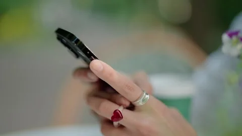 Woman's hand with heart ring scrolling on a smartphone Stock Footage 342741381