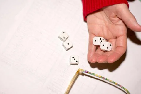 Womans hand holding dice Stock Photos