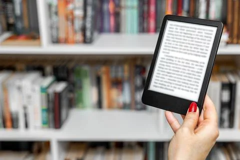 A woman's hand holding an e-book. Stock Photos