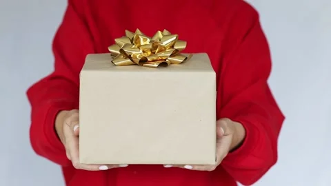 Woman's hand holding a gift box with a bow. Delivery Express, Christmas Sale Stock Footage 165182419
