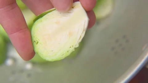 Woman's hand holding halved cabbage Stock Footage