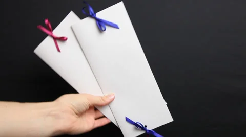Woman’s hand holding holiday envelope, black background Stock Footage 33394095