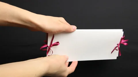 Woman’s hand holding holiday envelope, black background Stock Footage 33396367