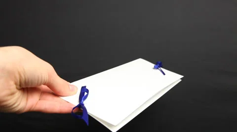 Woman’s hand holding holiday envelope, black background Stock Footage 33397152