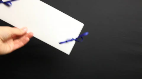 Woman’s hand holding holiday envelope, black background Stock Footage 33398058