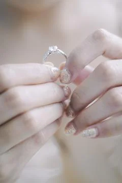 Woman's hand holding a ring Stock Photos