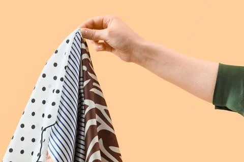 Womans hand holding a selection of patterned fabrics, fashion and textile ind Stock Photos