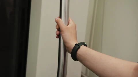 A womans hand holds onto the handle on a Naples subway train Vidéo 341963211