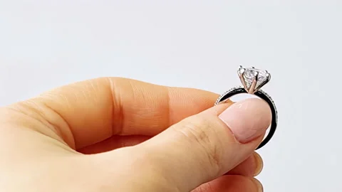 Womans hand holds wedding ring. Stock Footage 237527432