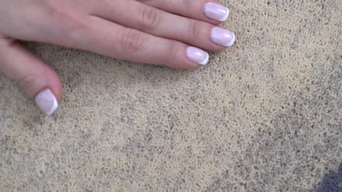 Woman's hand holds on wool carpet Stock Footage 101324585