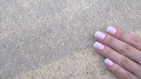 Woman's hand holds on wool carpet Stock Footage 101324650
