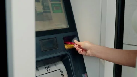 Woman's hand inserting a credit card into an ATM machine Stock Footage 343909658
