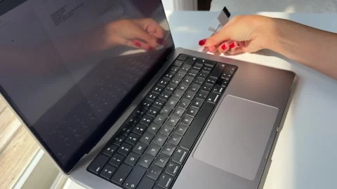 Woman's hand inserting a memory card adapter into a laptop Stock Footage 342066026