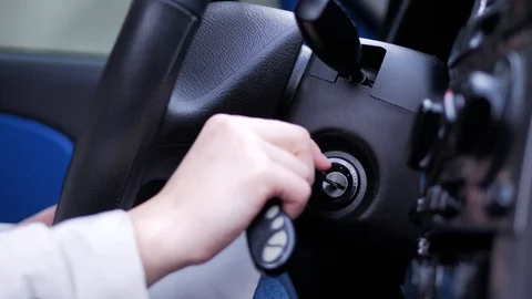 A woman's hand inserts the ignition key into the lock. Female driver concept. Stock Footage 106550192