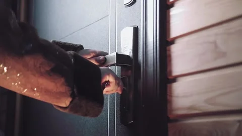 A woman's hand inserts the key into the keyhole, turns it unlocks the door and Stock Footage 151606126