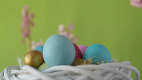Woman's hand lays down colourful Easter eggs Stock Footage 148290030