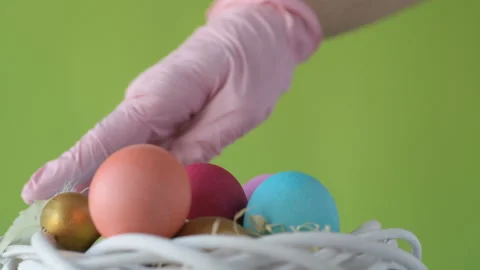 Woman's hand lays down colourful Easter eggs Stock Footage 148290195