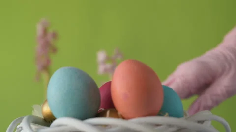 Woman's hand lays down colourful Easter eggs Stock Footage 148290243