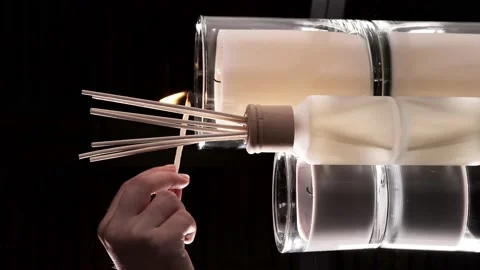 A woman's hand lights scented candles with a match. Romantic dinner Stock Footage 209149122