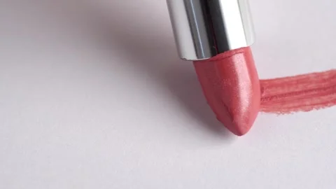 A woman's hand with lipstick making a mark on a white background. Cosmetic .. Stock Footage 247549799