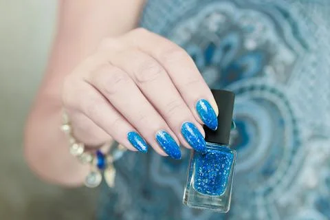 Woman's hand with long nails and blue manicure Photos