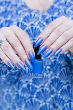 Woman's hand with long nails and bright blue manicure Stock Photos